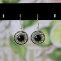 Miao ethnic silver earrings with geometric flower disk design and turquoise accents