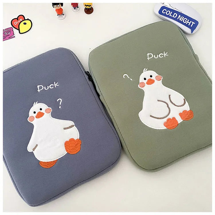 Blue cotton tablet case with embroidered cartoon duck design, zipper closed.