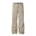 Men's loose straight-leg cotton trousers in brown, showing high waist and zipper fly.