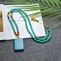 Turquoise stone mesh flower pendant on a silver ball bead necklace, adjustable length.