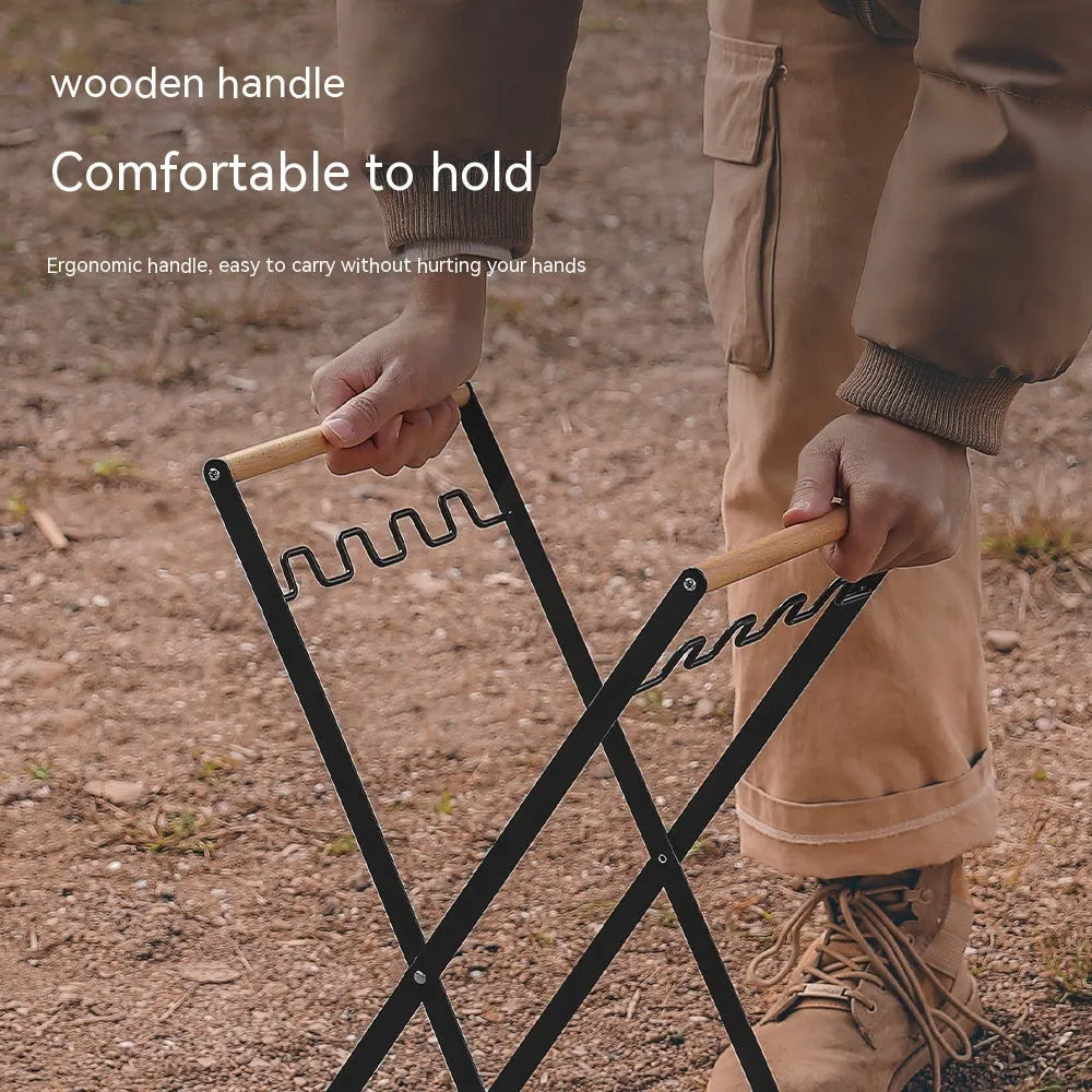 Black outdoor folding iron trash rack with a wooden handle, holding a bin bag.
