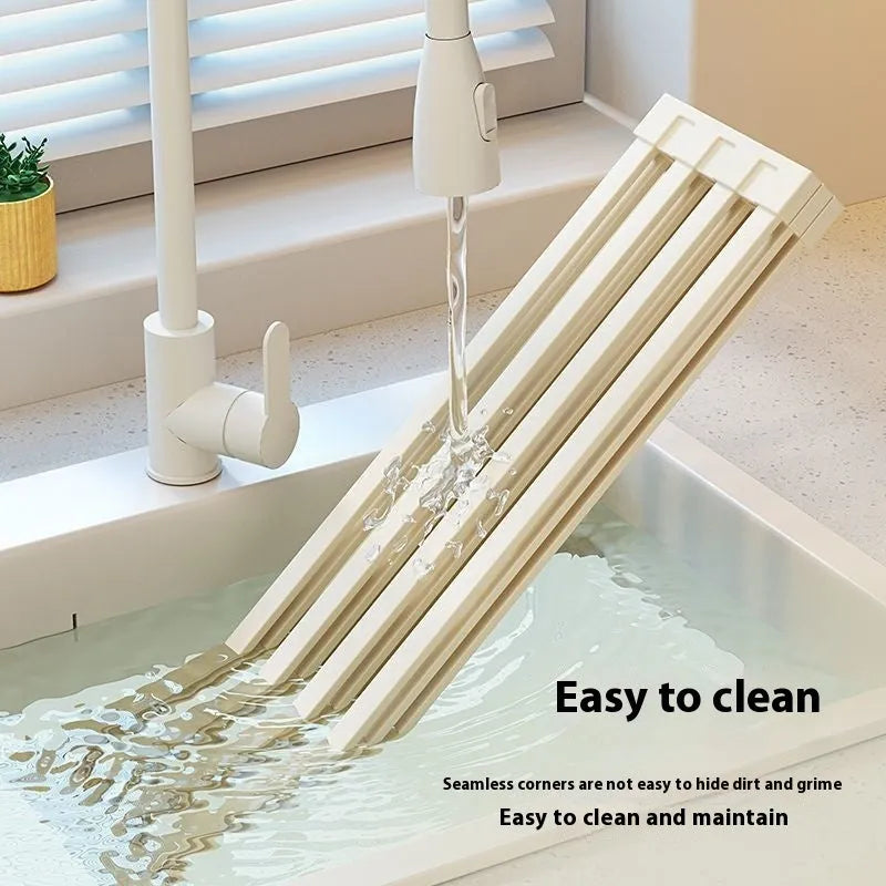 Foldable milky white stainless steel kitchen draining rack showing tri-fold design