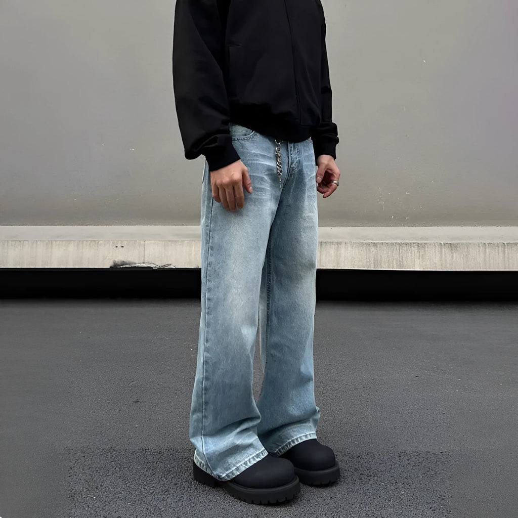 Men's blue straight leg jeans with whisker washing and flared leg style on medium-high waist