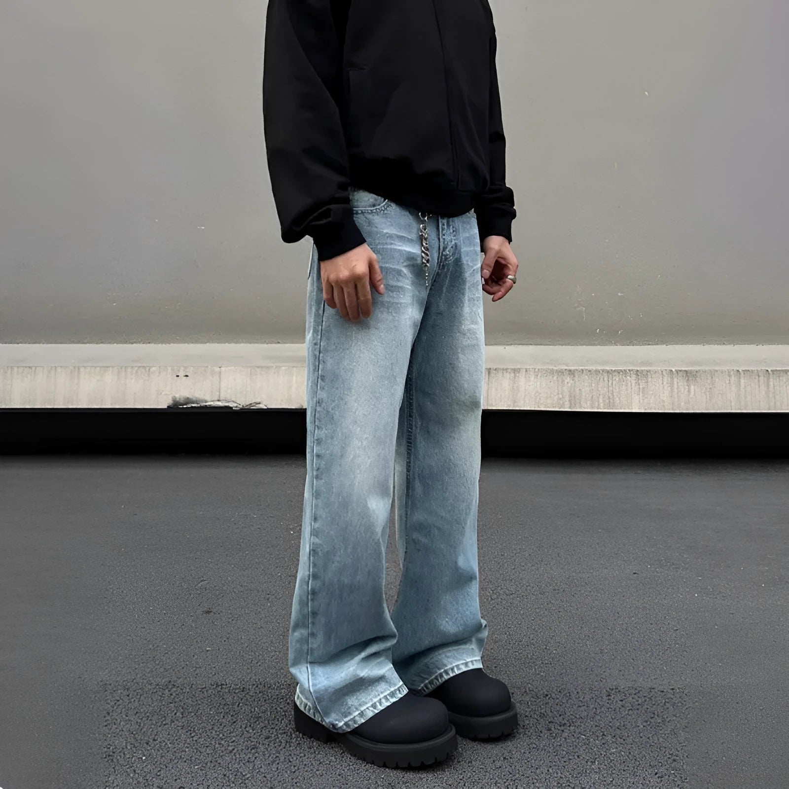 Men's blue straight leg jeans with whisker washing and flared leg style on medium-high waist