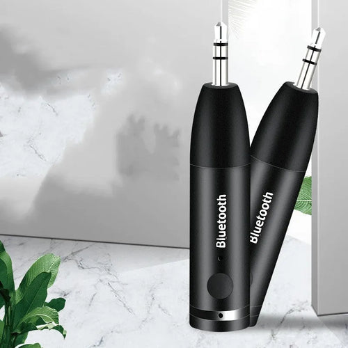 Black AUX Bluetooth 5.0 audio receiver for car stereo with USB charging cable