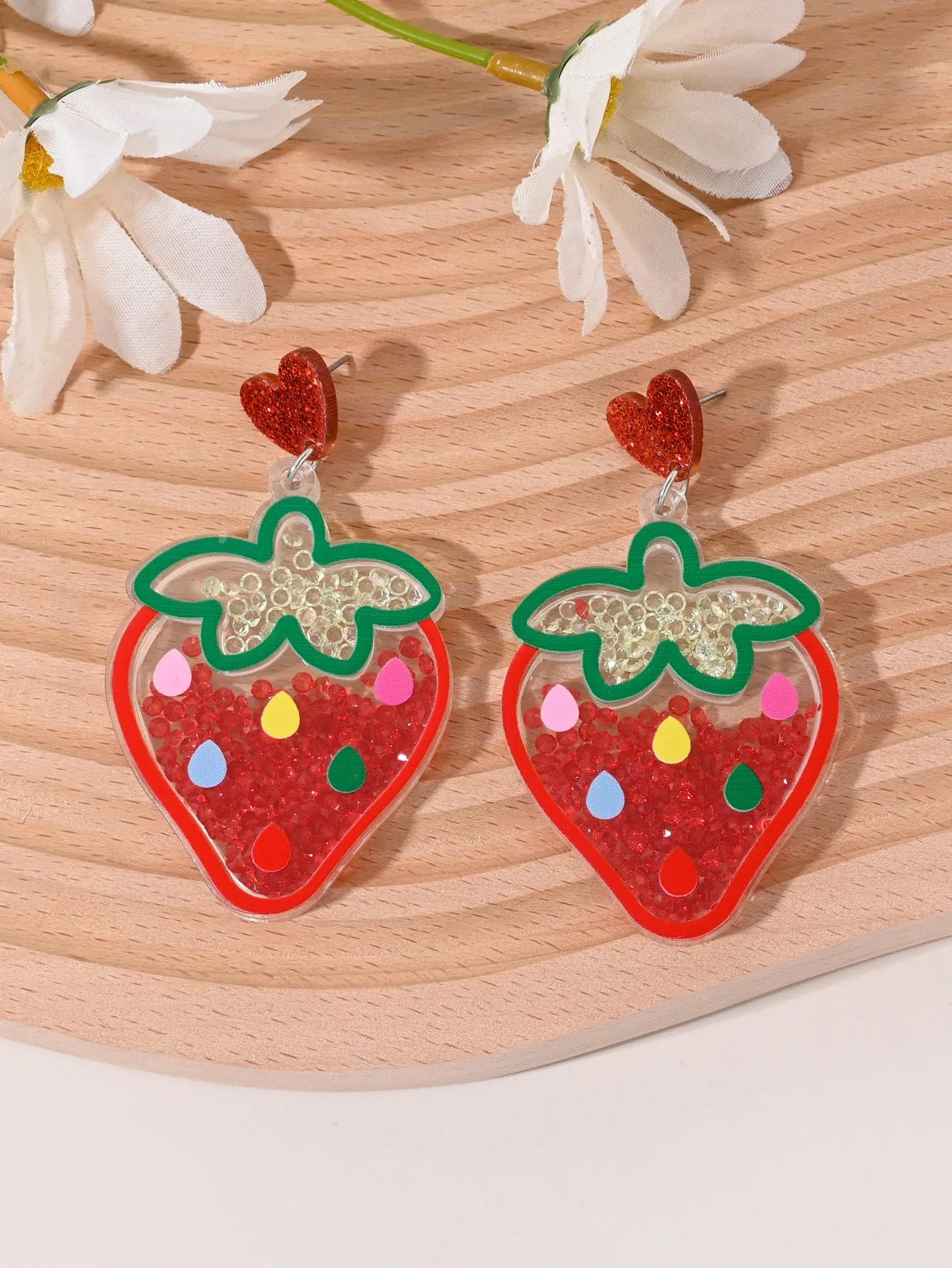 Colourful acrylic earrings with fruit and dessert designs including cherry, strawberry and watermelon shapes