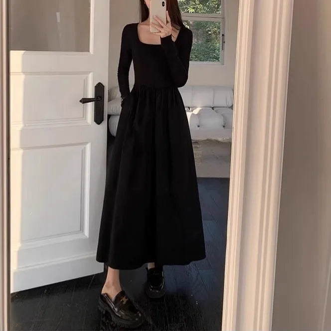 Women's black square collar knitted A-line dress with long sleeves on a hanger.