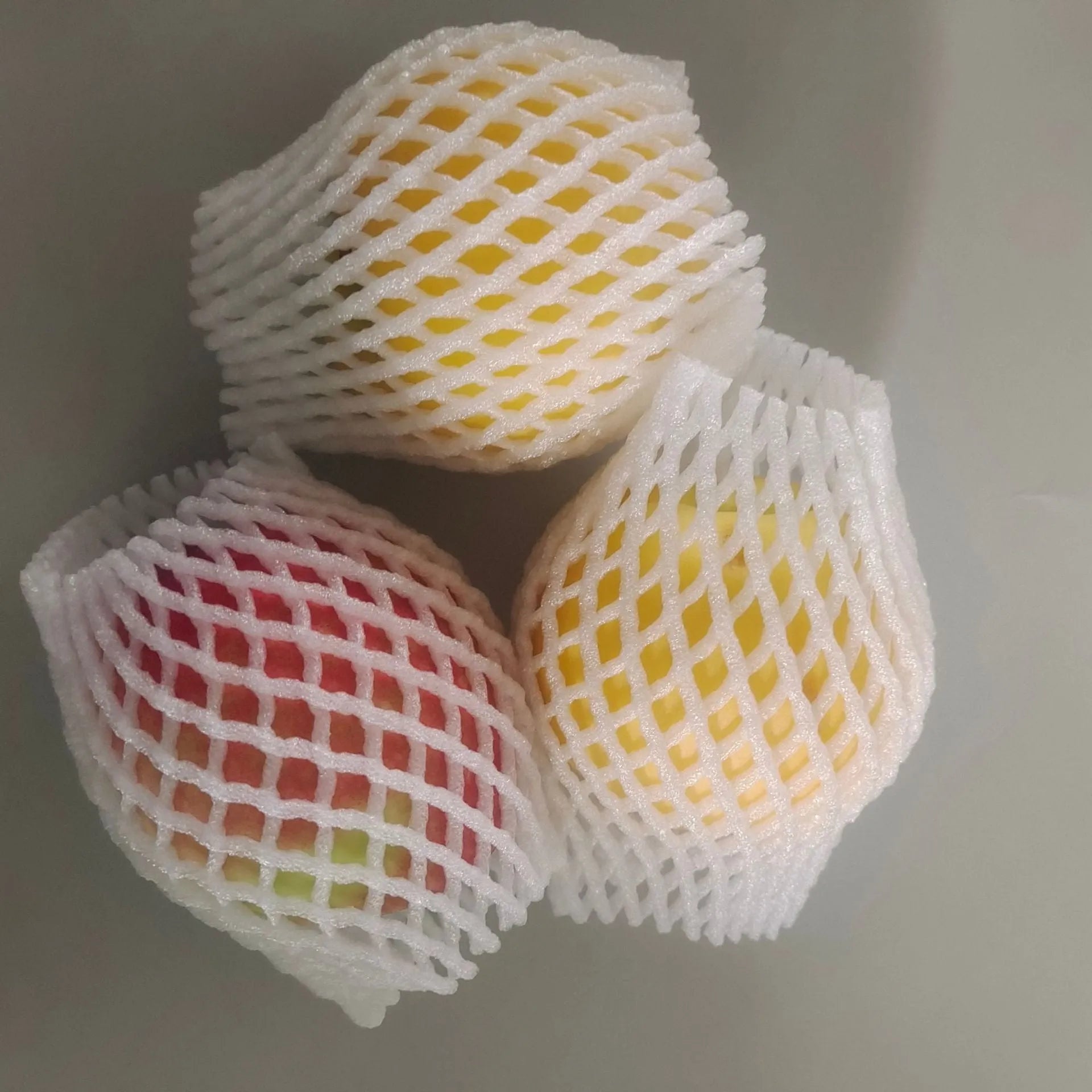 White foam net protective cover for colourful fruit cases available in multiple sizes