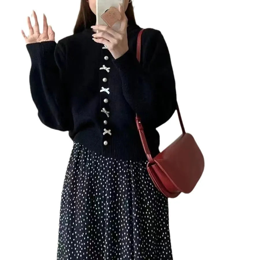 Women's solid colour cardigan sweater with bow-shaped pearl buttons on the front.