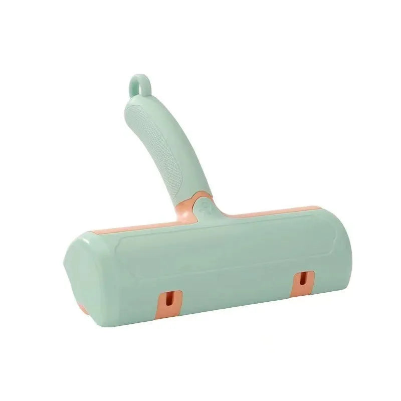 Mint green manual brush for removing cat hair from furniture and fabrics, showing its size.