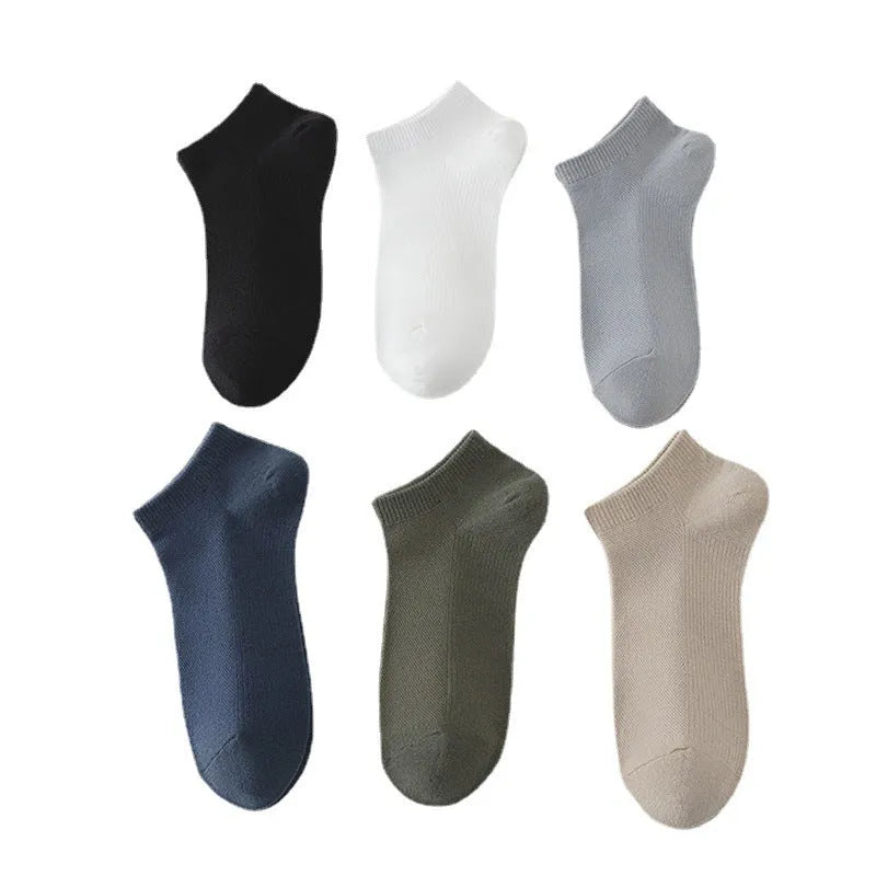A pair of solid colour low-cut polyester boat socks for men, shown in one of six available colours.