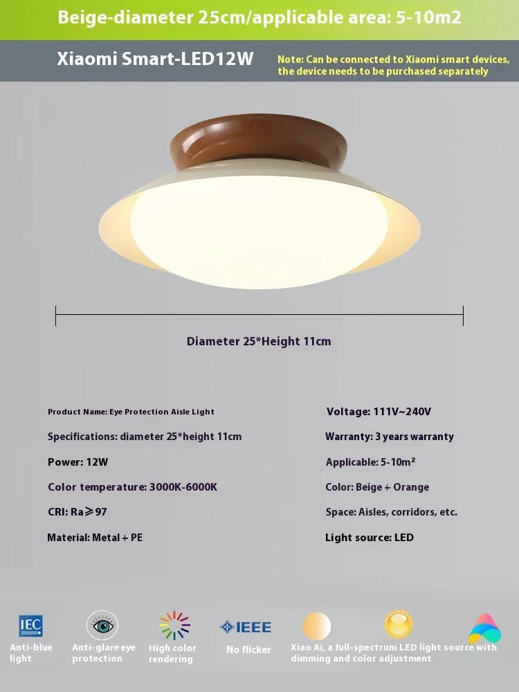 Modern minimalist cream style flying saucer ceiling lamp in mint green on a white ceiling.