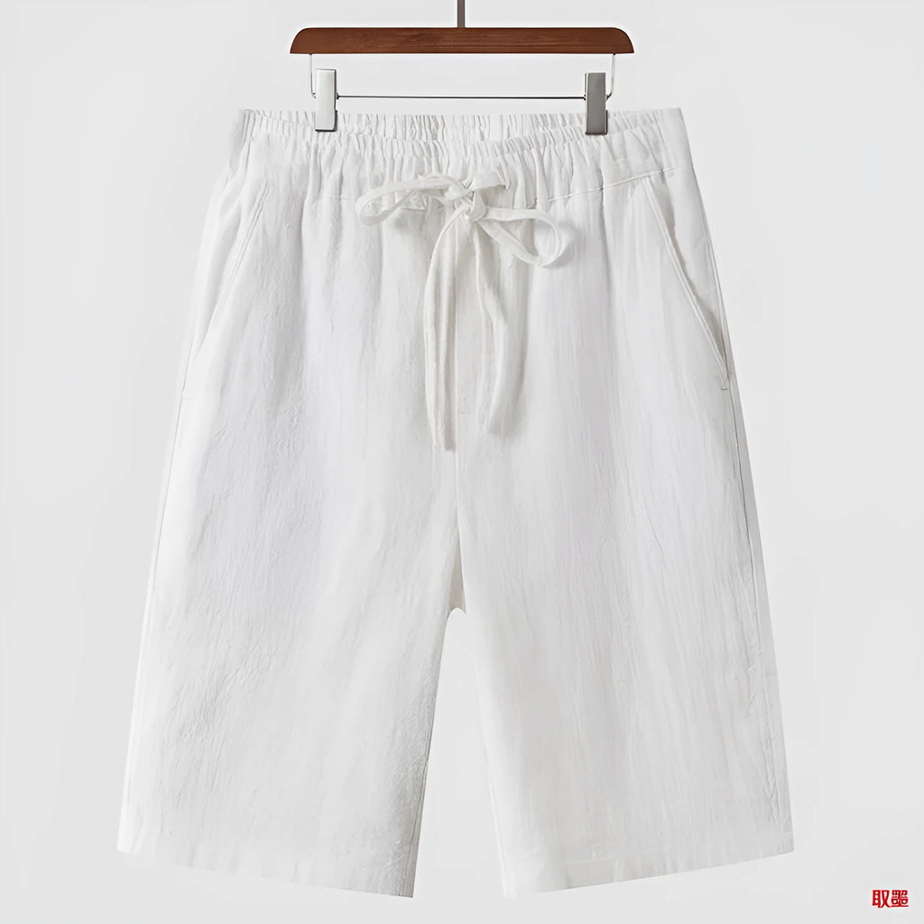 Men's loose-fit linen shorts in a cropped mid-length style with an elastic waistband.