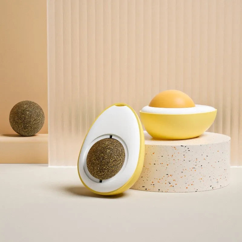 Soft plush catnip ball toy in egg shapes stuck to a wall for interactive cat play.