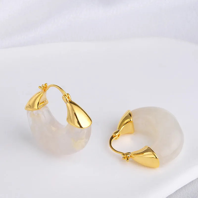Copper geometry shape retro Maillard style earrings with electroplated finish in amber colour option on plain background
