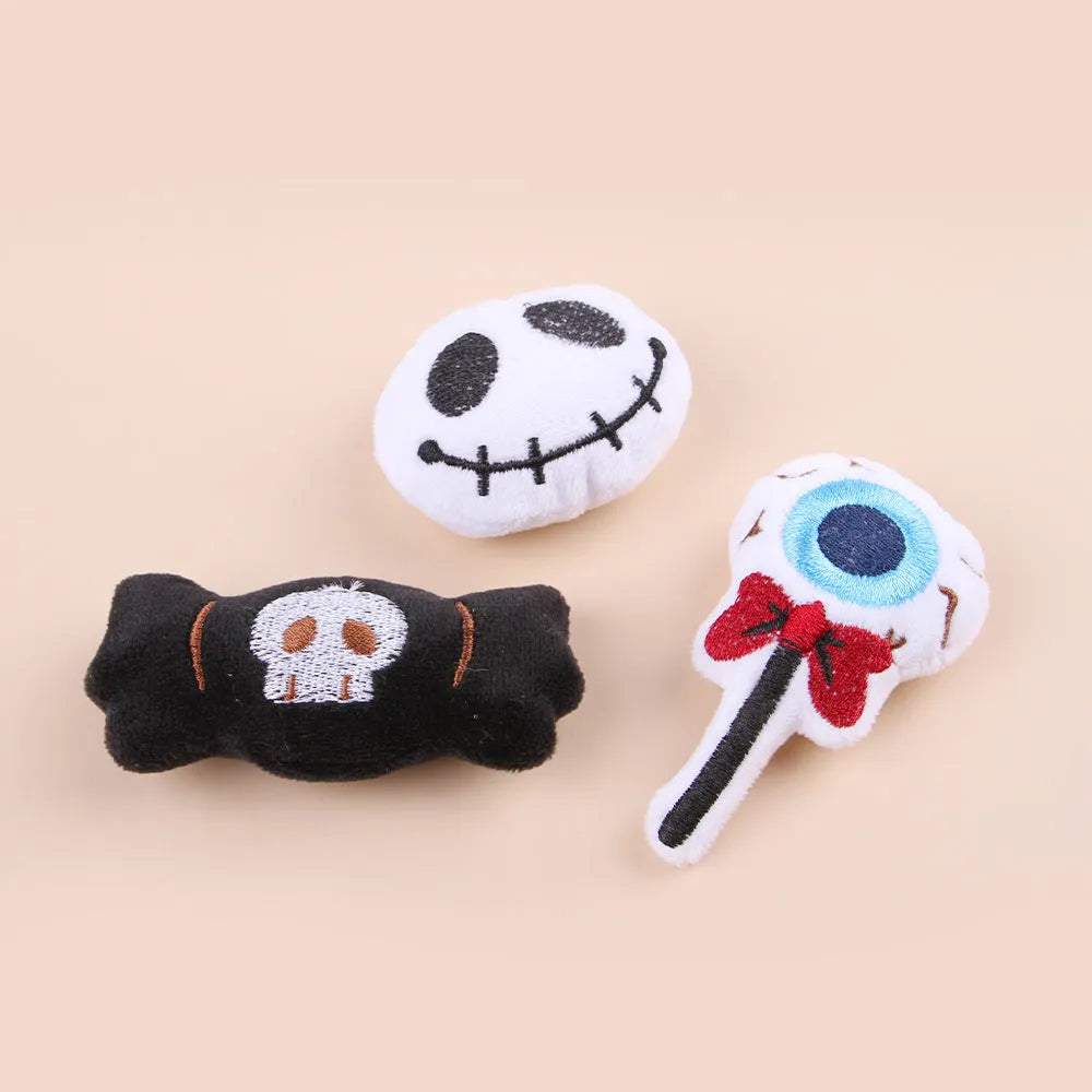 Small cat teaser wand with dangling plush candy, eye, and skull toy attachments