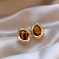 Handmade alloy holiday earrings set showing three geometric styles with tassel elements