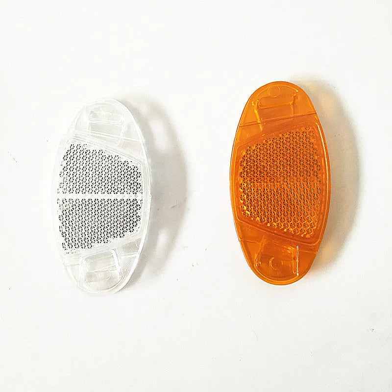 White and yellow plastic bicycle reflector stickers for spoke mounting measuring 7.2cm by 3.5cm