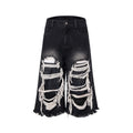 Woman wearing black cropped wide-leg jeans with a mid-high waist and ripped patchwork details