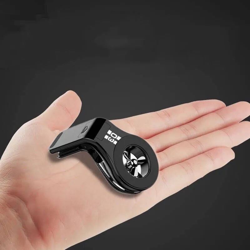 Black magnetic car air vent phone holder with adjustable rotation paddle showing phone mounting position