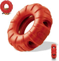 Blue natural rubber tyre-shaped dog chew toy with six oval openings, shown next to a red and green version.