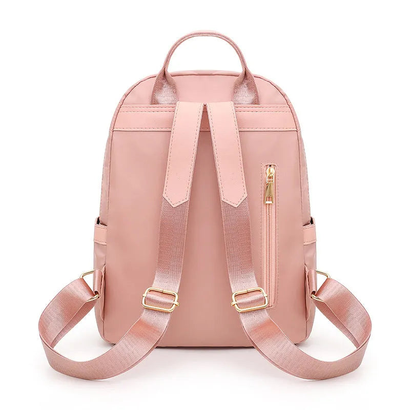 Women's black casual nylon backpack with shoulder straps showing external pockets and organised interior compartments