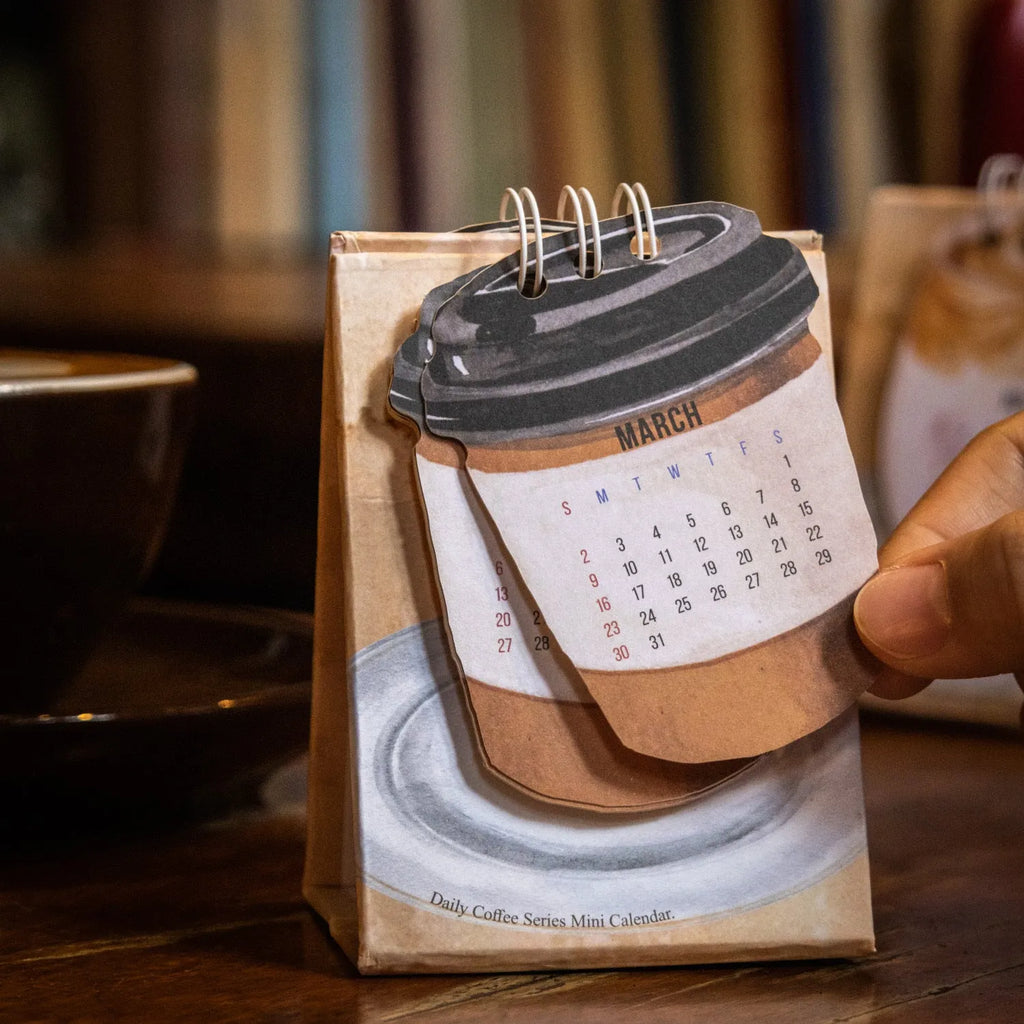 Mini 2025 desk calendar showing four design options including coffee time and motivational phrases