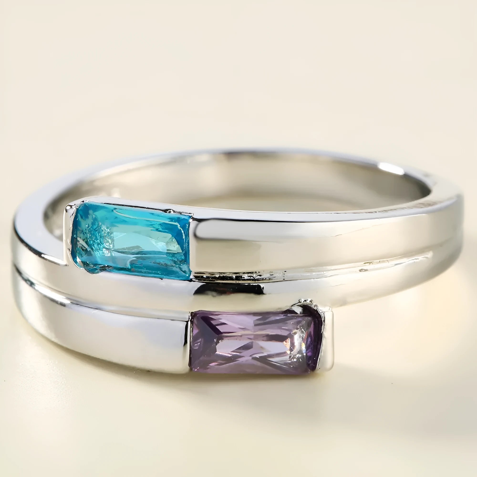 Silver electroplated copper ring with a zircon inlay, shown in a unisex design.