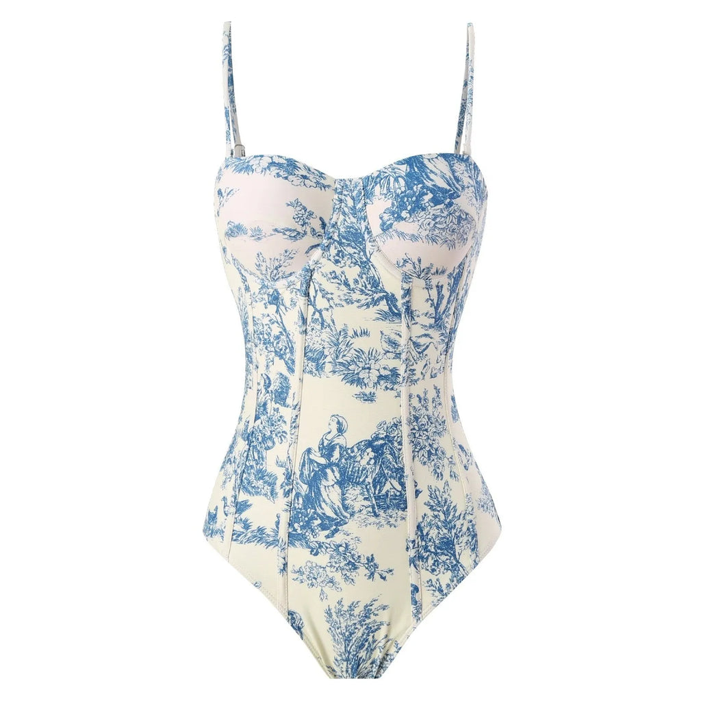 Blue patterned women's one-piece swimsuit shown with a matching light gauze skirt.