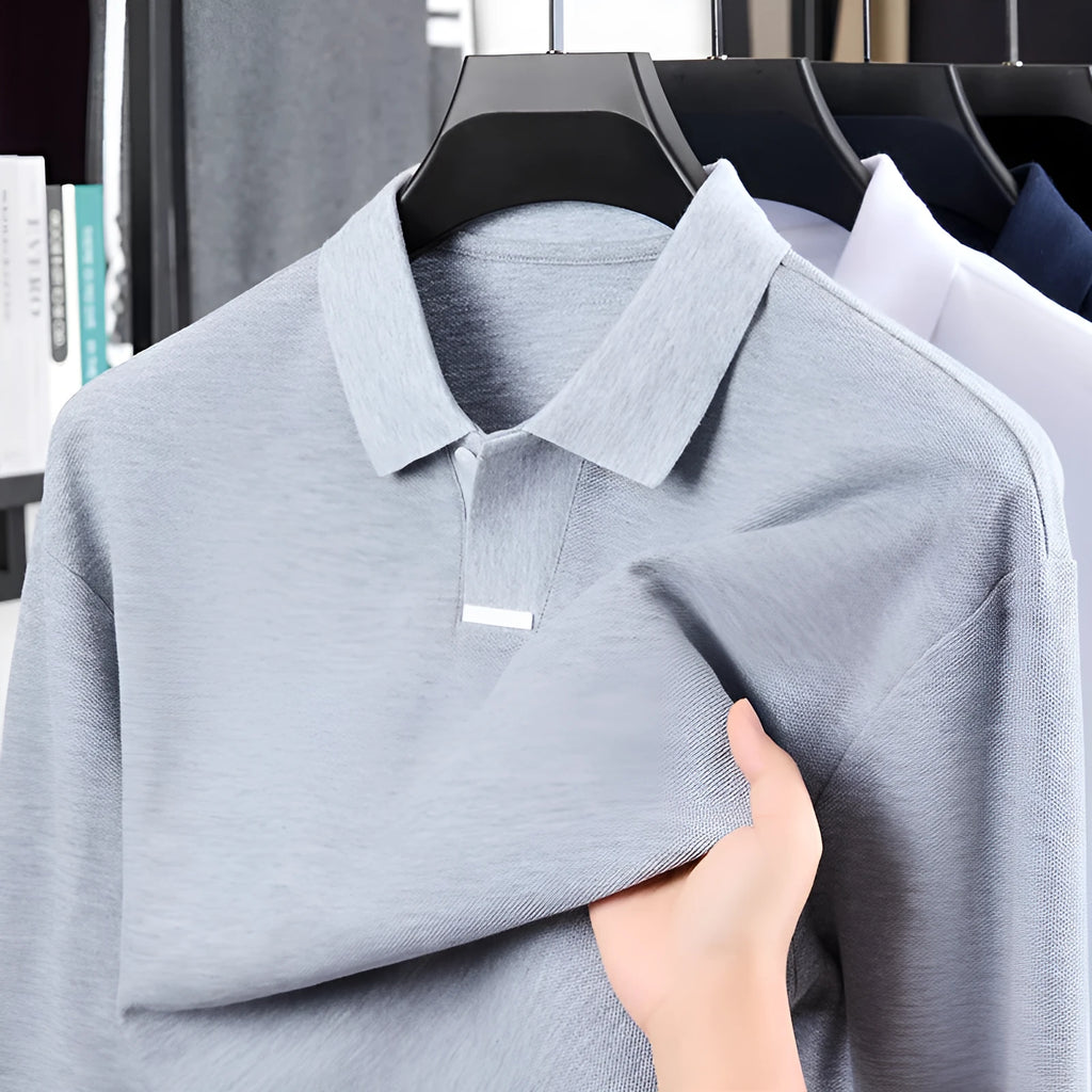 Men's loose-fit cotton polo shirt with lapel collar in grey, shown on a model.