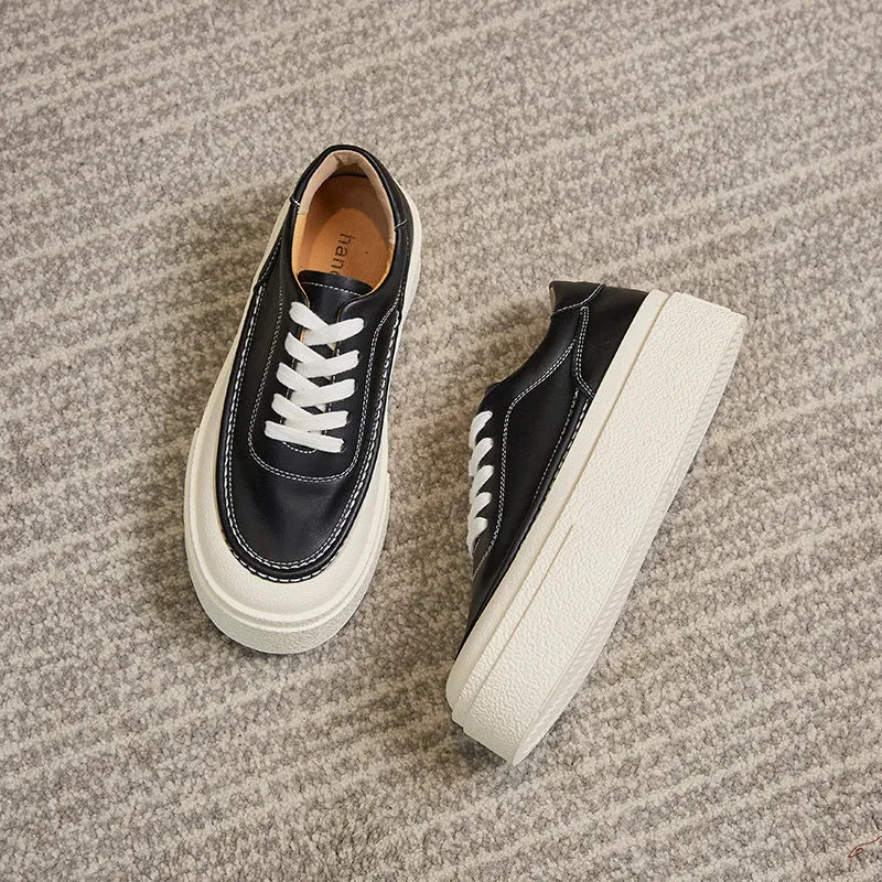 Women's black platform sports board shoes made from embossed cowhide leather with a rubber sole.