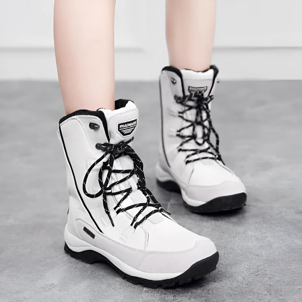 Women's mid-calf length black genuine leather thermal snow boots with a round toe and rubber sole