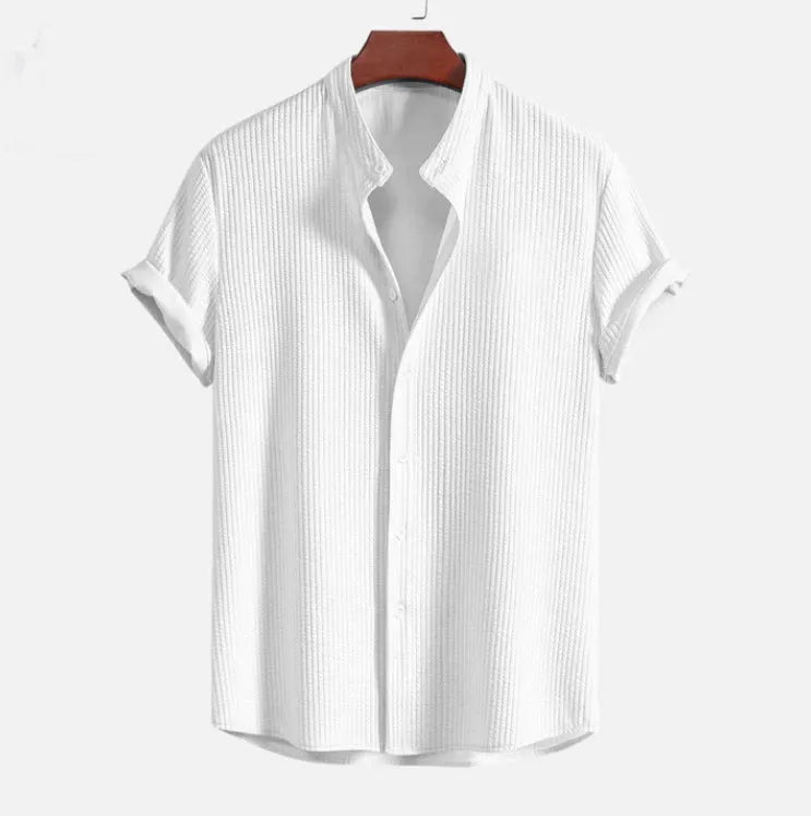Man wearing a loose-fit short sleeve casual shirt in a solid colour, available in multiple sizes.