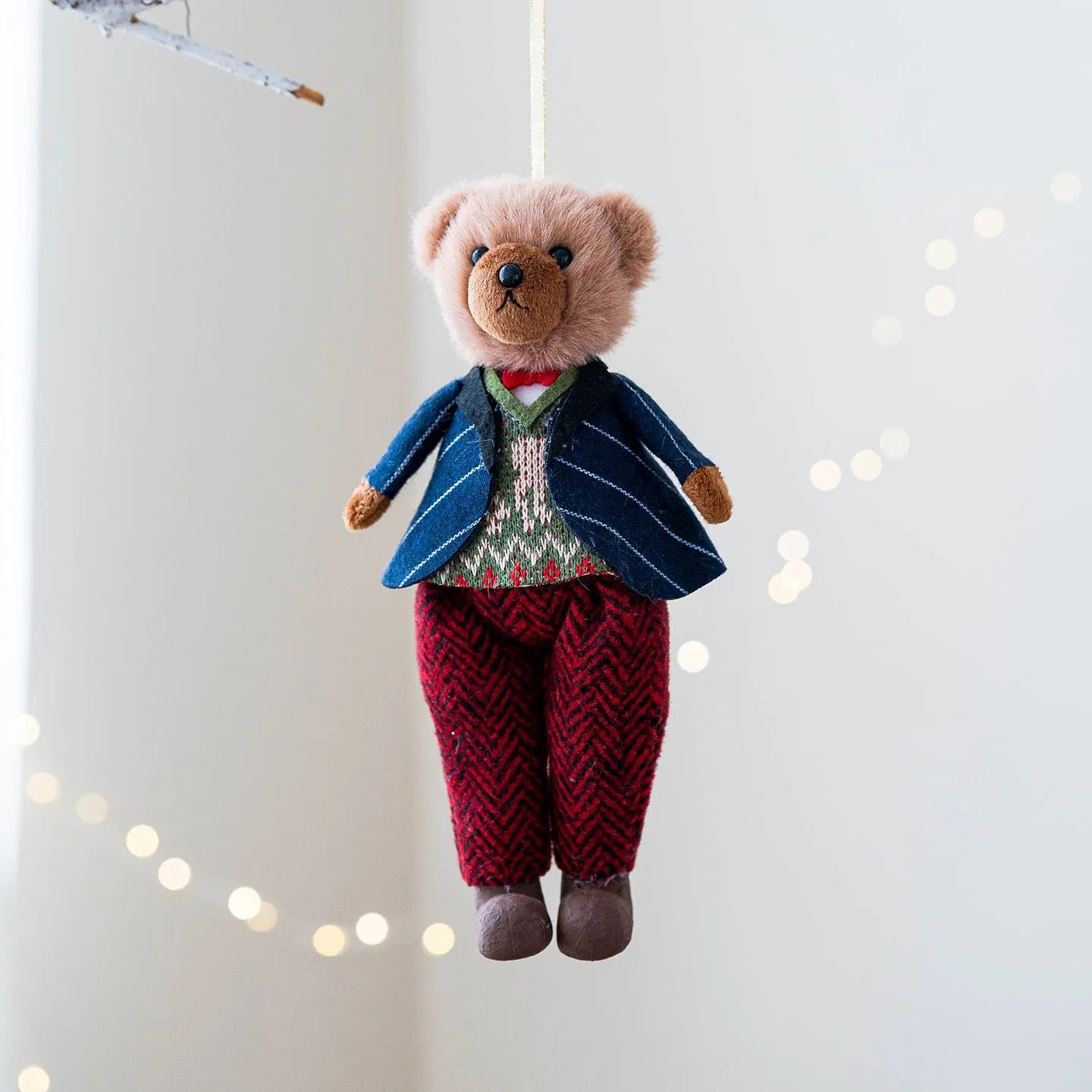 Pair of plush bear dolls wearing red and black plaid cotton clothing, cartoon style.
