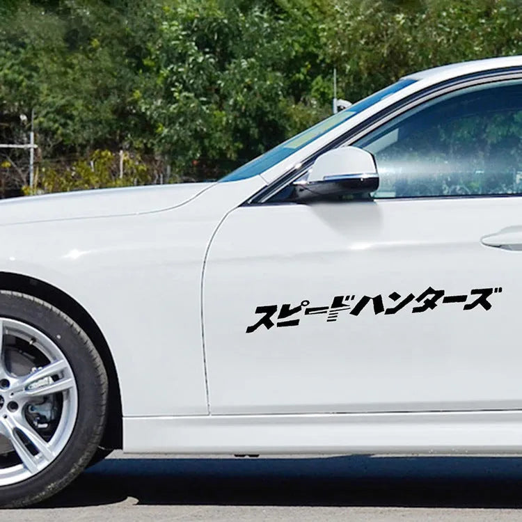 Black and white reflective Japanese car sticker measuring 35x35cm on a vehicle window.