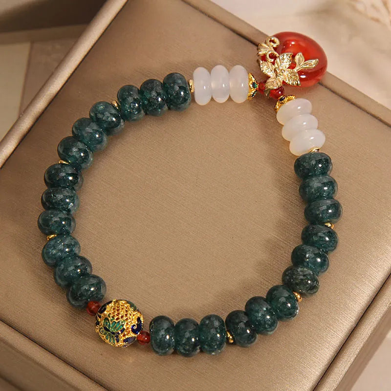 Blue water jade and red agate bracelet with peace buckle charm and rhinestone details