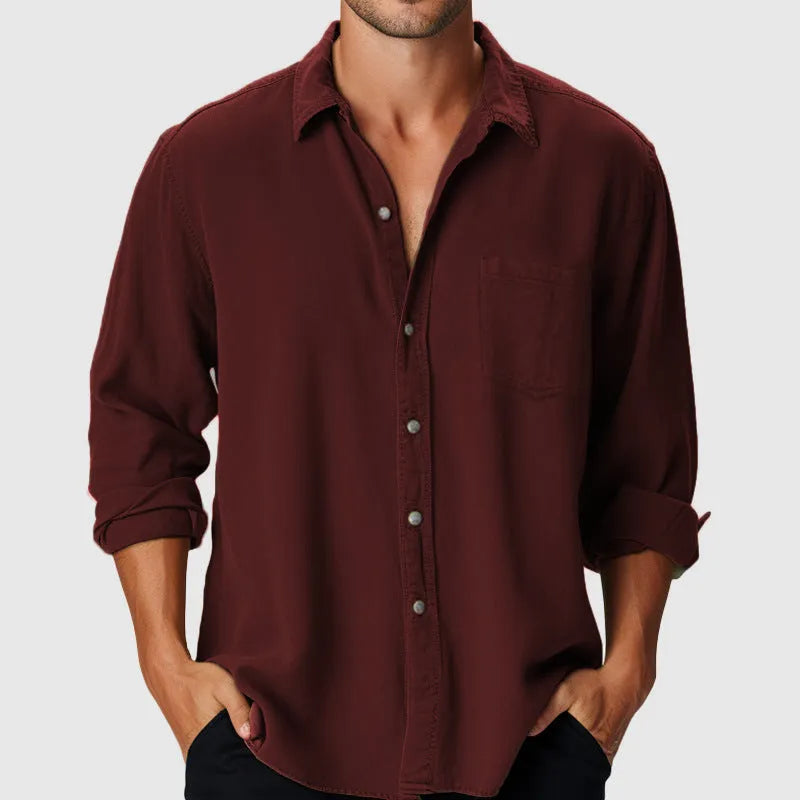 A man's loose-fitting long sleeve beach shirt with a stand collar, shown in a solid colour.