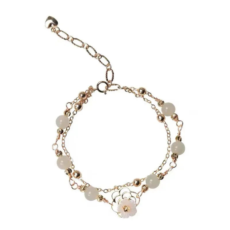 Women's yellow gold butterfly bracelet made from electroplated copper with a geometric shape.