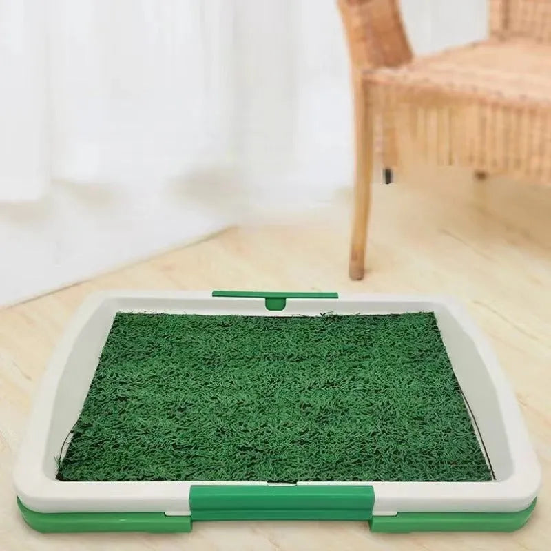 Green synthetic turf dog toilet tray with a plastic base for indoor puppy potty training.
