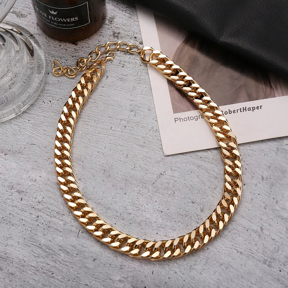 Women's gold coloured thick chain alloy necklace showing 32cm length and 6cm wide links.