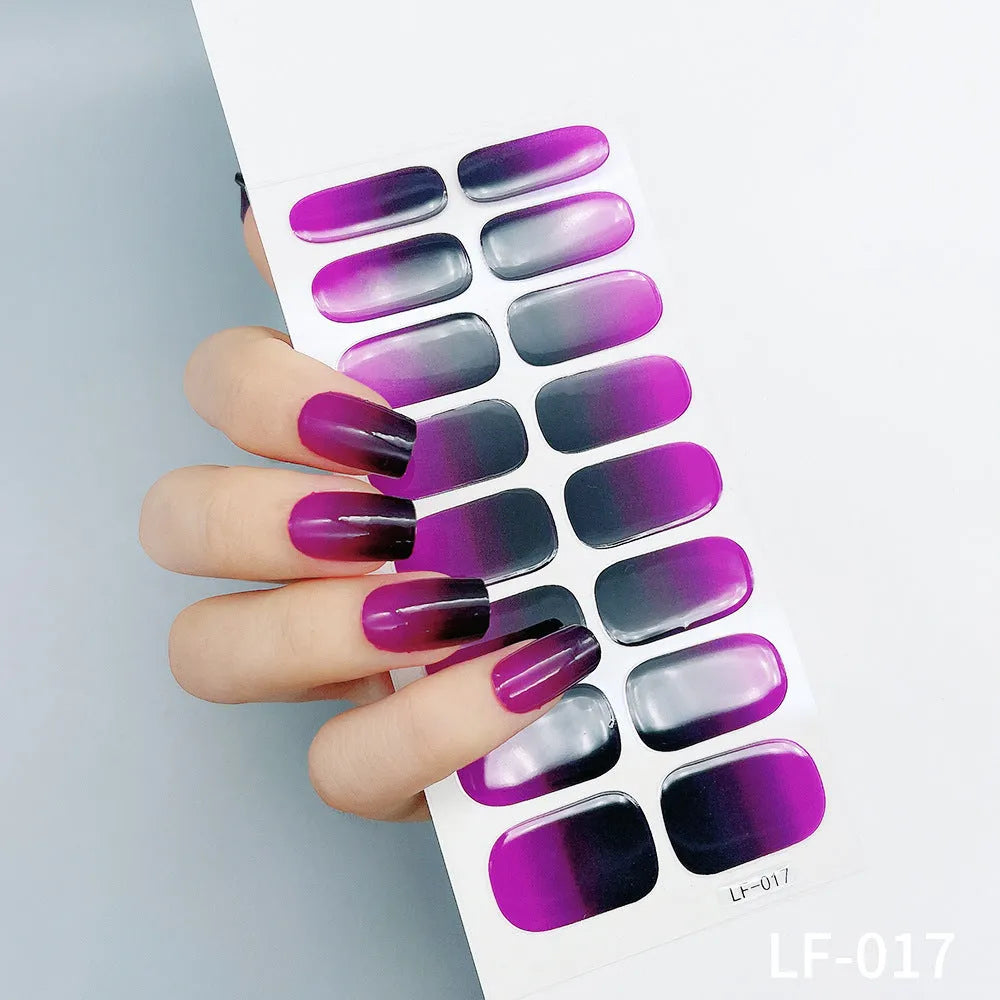 Full sheet of nail art stickers showing sixteen small designs including cross, rose, tulip, and leopard print patterns.