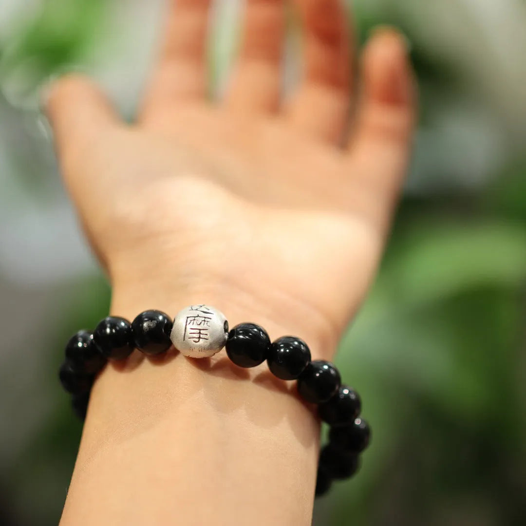 Natural black agate beaded bracelet with sterling silver clasp showing Chinese style threading