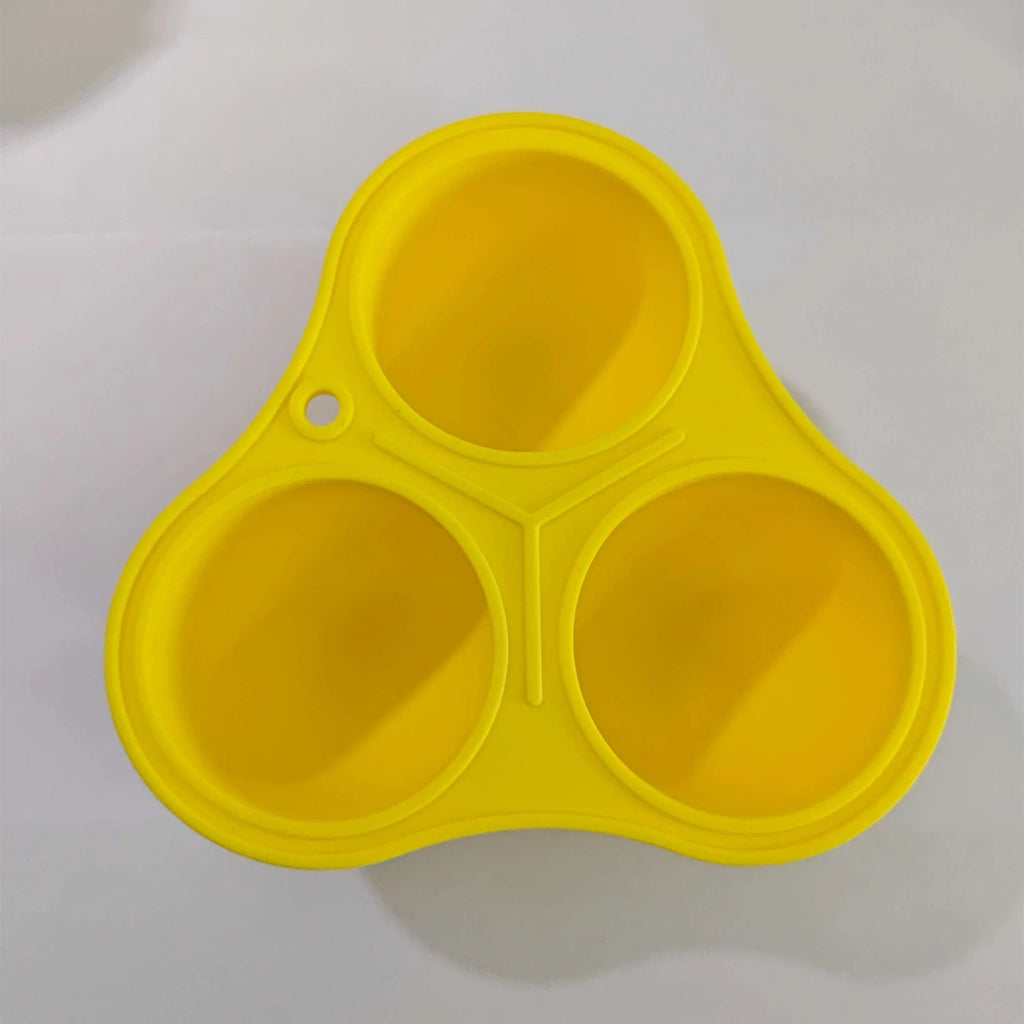 Yellow silicone dog toy ball with snack mould for slow feeding and dental care