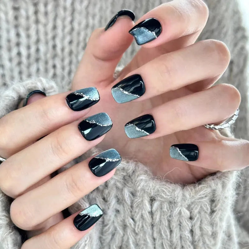 Set of colourful artificial false nails with glitter designs for DIY manicures.
