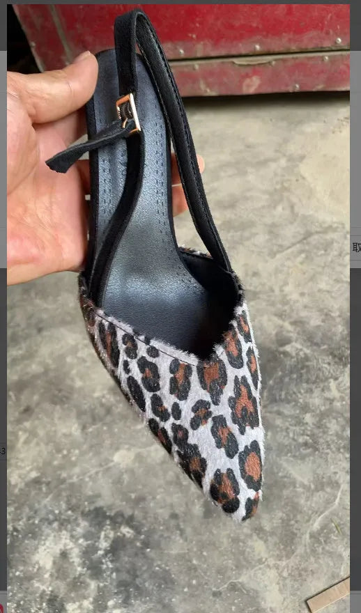 Leopard print women's suede sandals with a pointed toe, shown from the side.