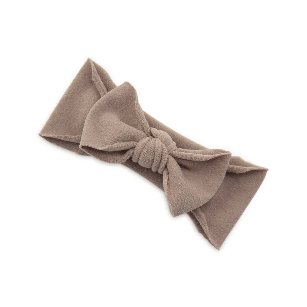 Solid colour knotted cloth headband for baby girls with bowknot design, available in 37 colours