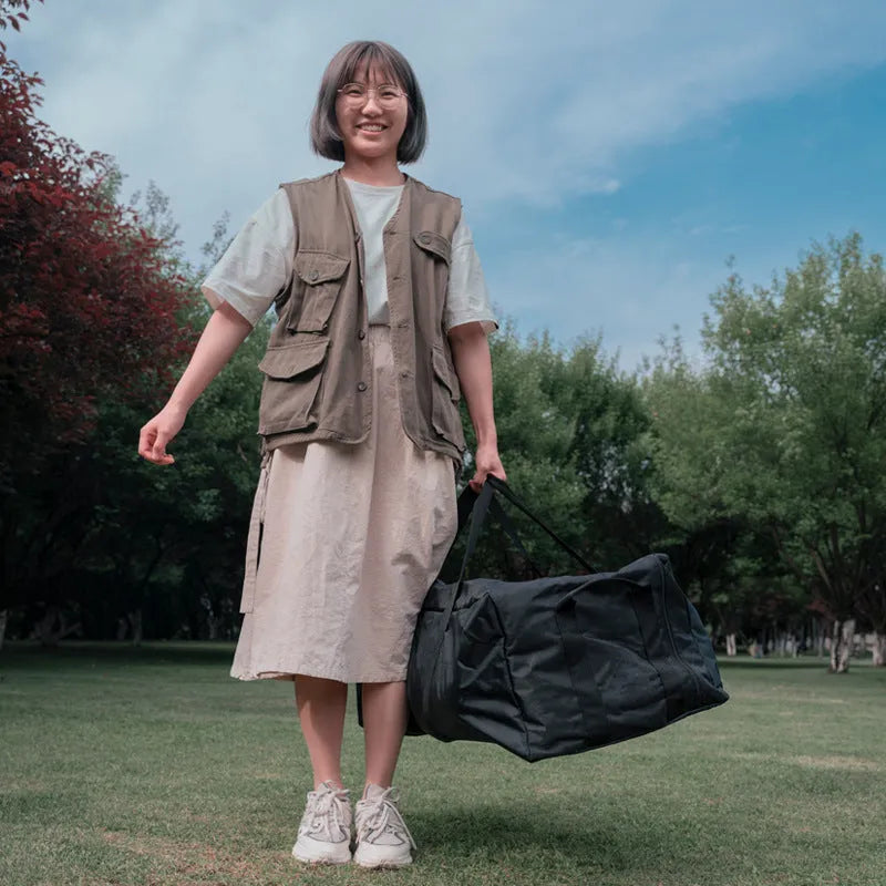 Large black waterproof storage bag for camping tables and chairs, shown folded and expanded, with 100L and 150L size options.
