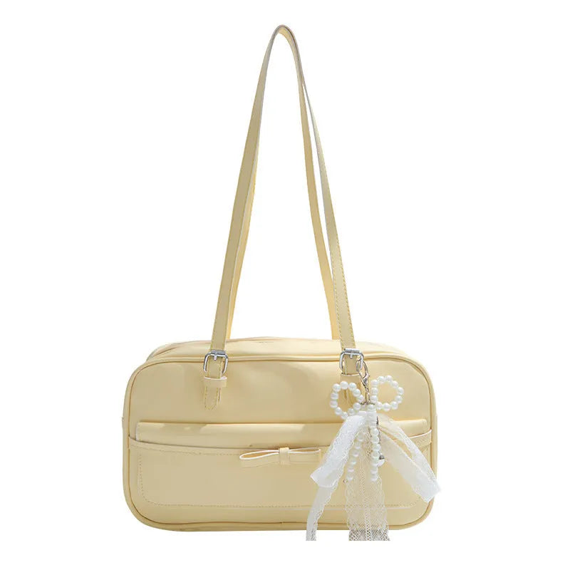 Single-shoulder flap bag in PU leather with bow stitching details and horizontal square shape