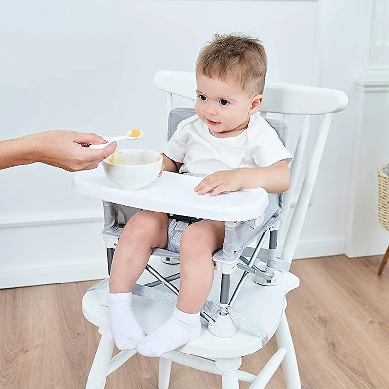 Foldable baby dining chair with metal frame, removable tray, and safety belt in grey