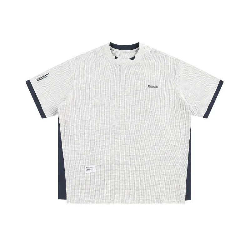 Retro alphabet embroidered loose waffle knit t-shirt in a fake two-piece style, shown in navy blue.